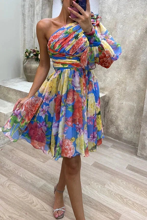 Blue women’s asymmetrical floral mini dress features a single puff sleeve and lightweight fabric for a breezy summer look.