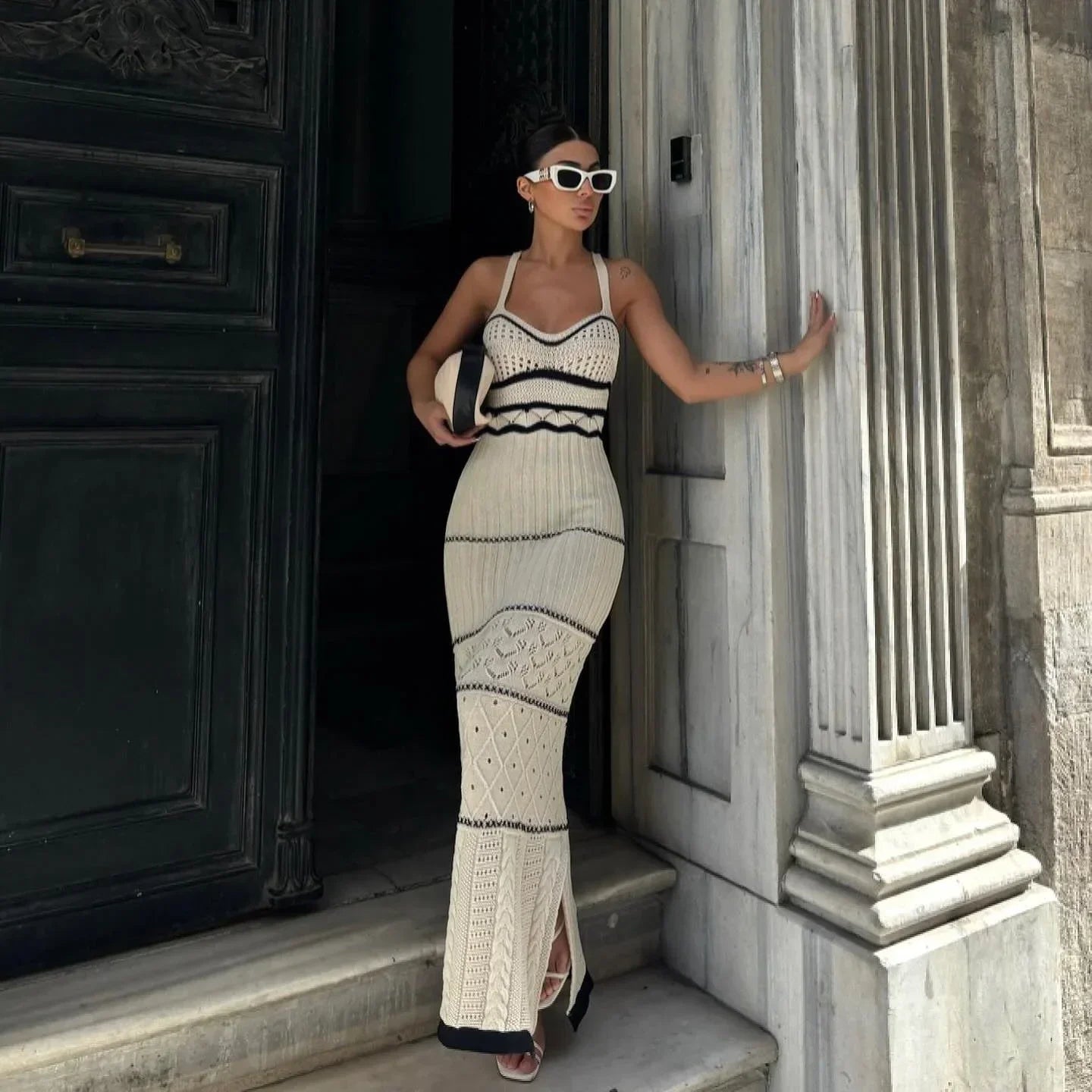 Women's beige fitted knit maxi dress with black accents, featuring a comfortable stretch fabric and a sleek silhouette.