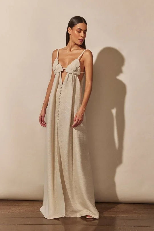 Women’s beige maxi dress made from soft fabric, featuring floral accents and a stylish front slit for ease of movement.