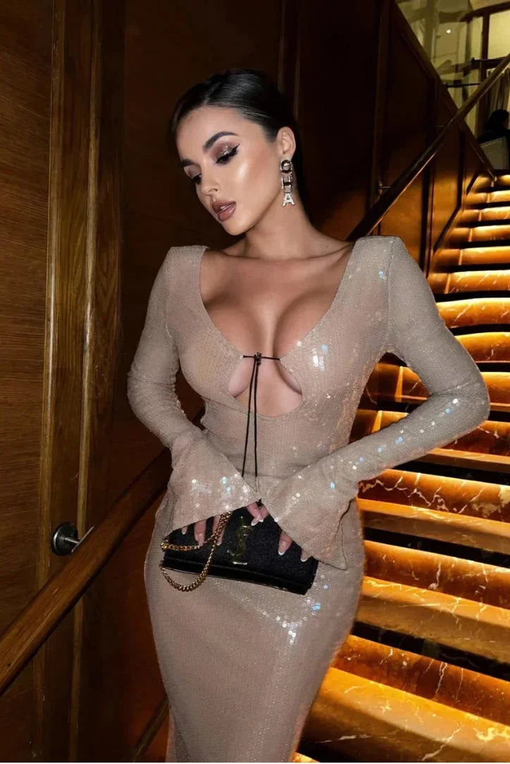 Women’s beige sequined maxi dress with long sleeves, deep v-neckline, and flowing silhouette for elegant occasions.