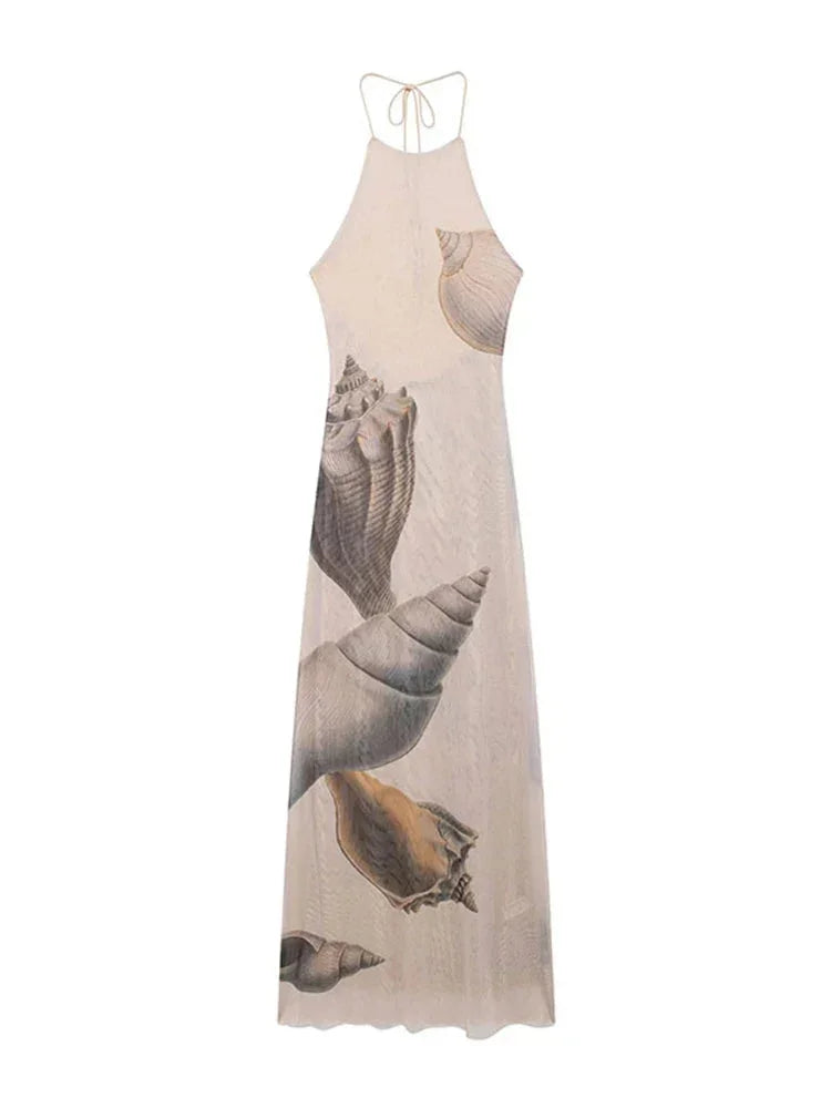 Women’s beige halter maxi dress with a shell print, featuring a lightweight fabric and flowing silhouette for comfortable…