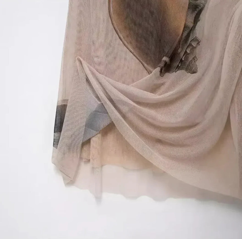 Beige halter maxi dress featuring a shell print design, crafted from lightweight fabric for comfort and style.