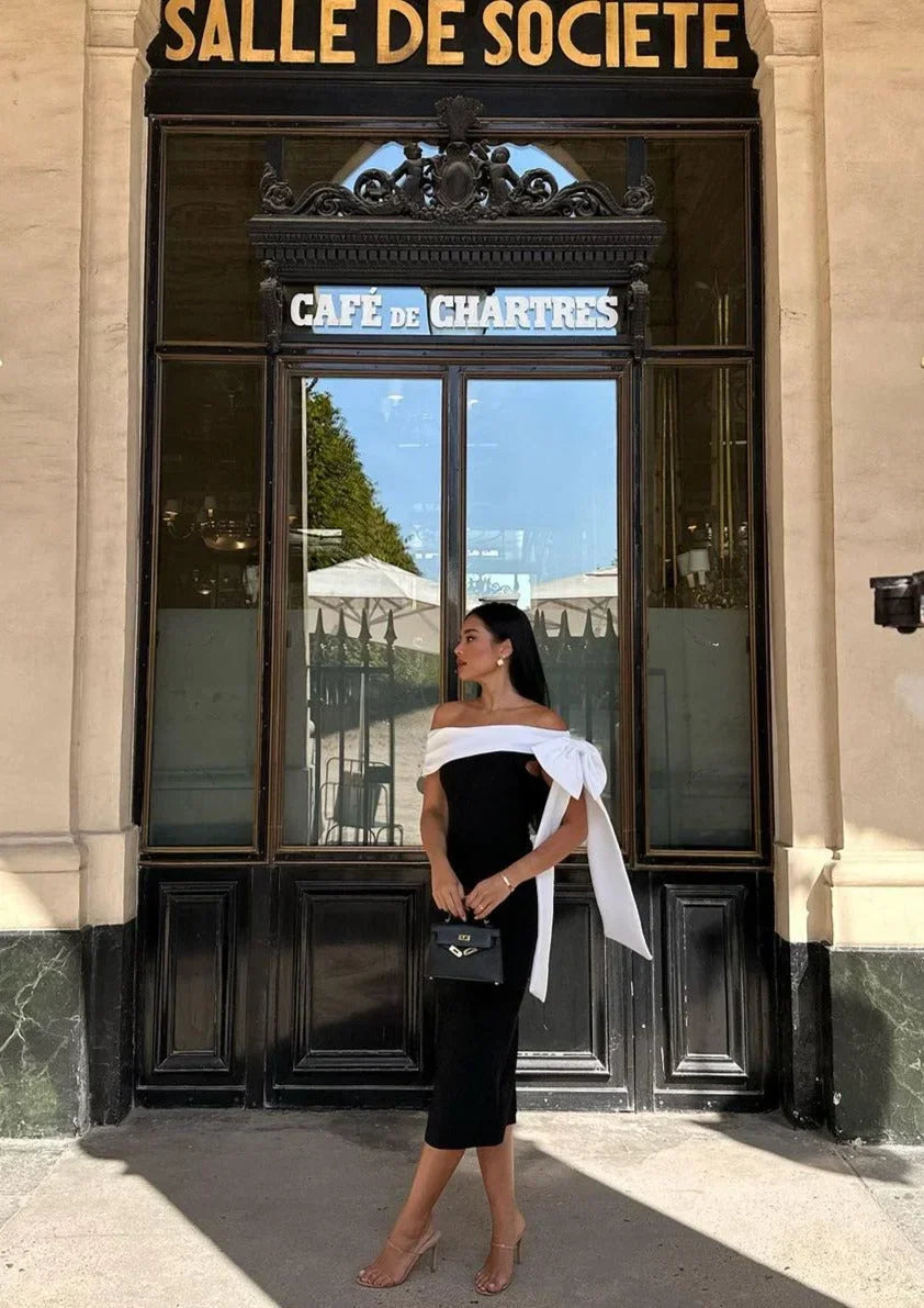 Women’s black and white one-shoulder midi dress featuring a bow accent and made from breathable fabric for a comfortable fit.