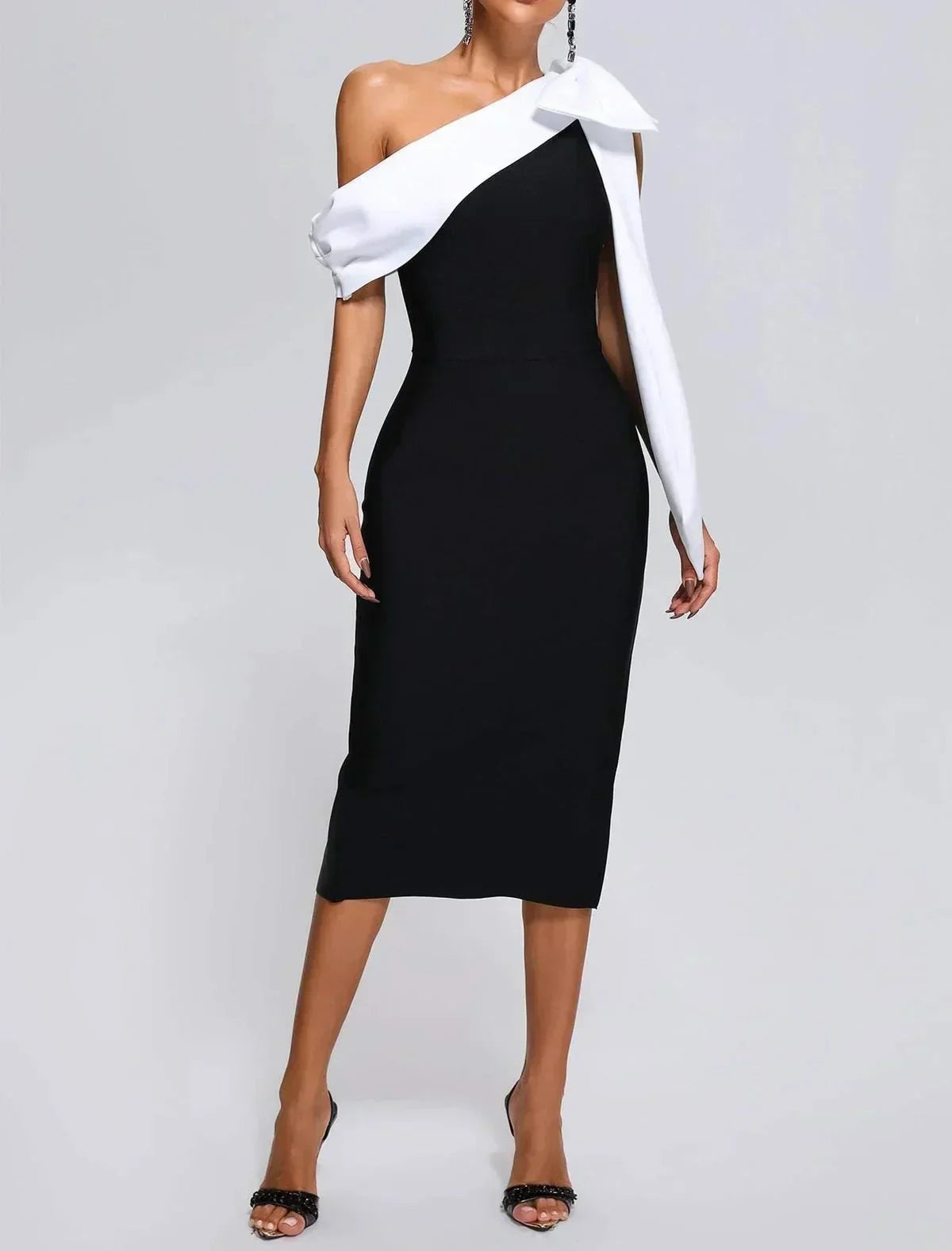 One-shoulder midi dress in black and white, featuring a bow accent and crafted from soft, breathable fabric.