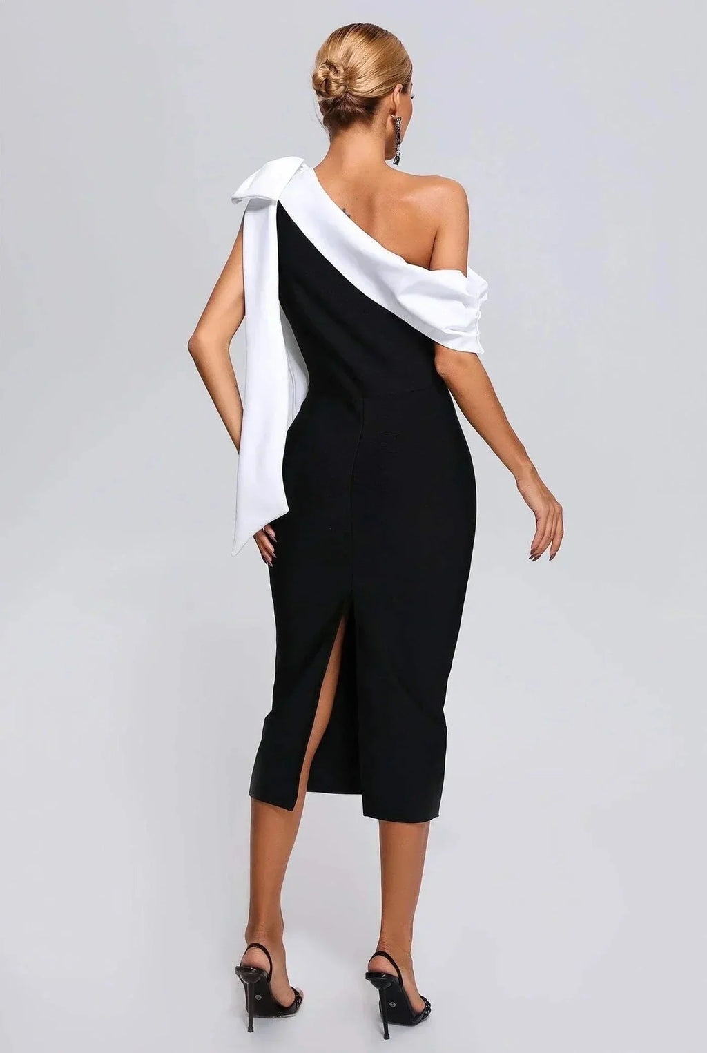 Women’s black and white one-shoulder midi dress with a bow accent, featuring lightweight fabric and a sleek silhouette.