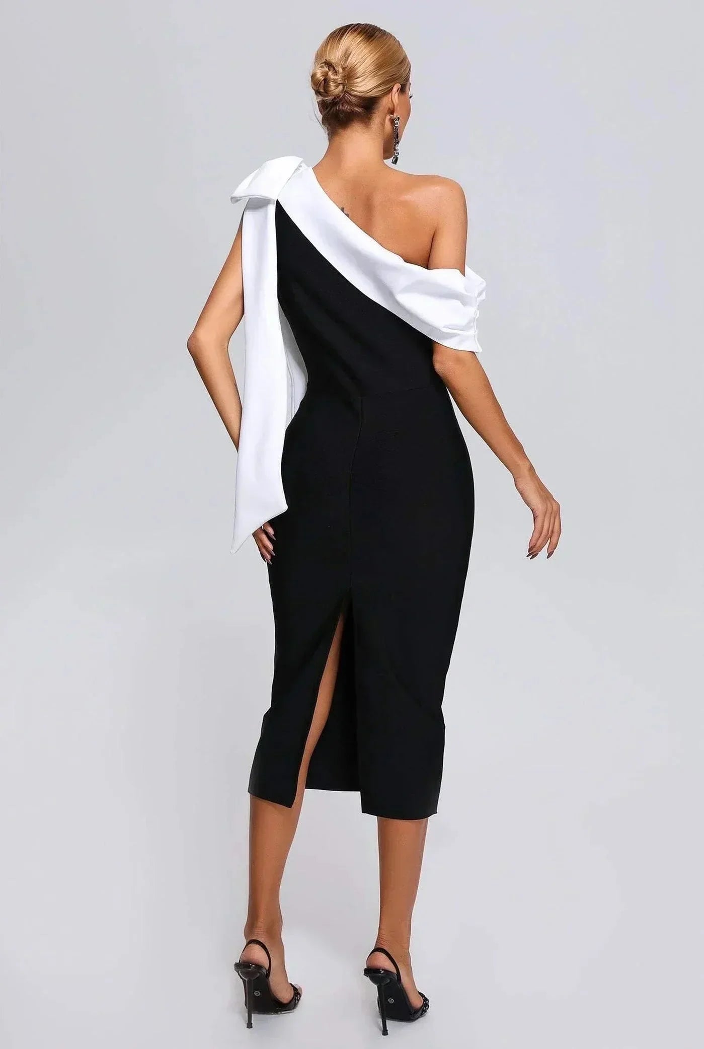 Women’s black and white one-shoulder midi dress with a bow accent, featuring lightweight fabric and a sleek silhouette.