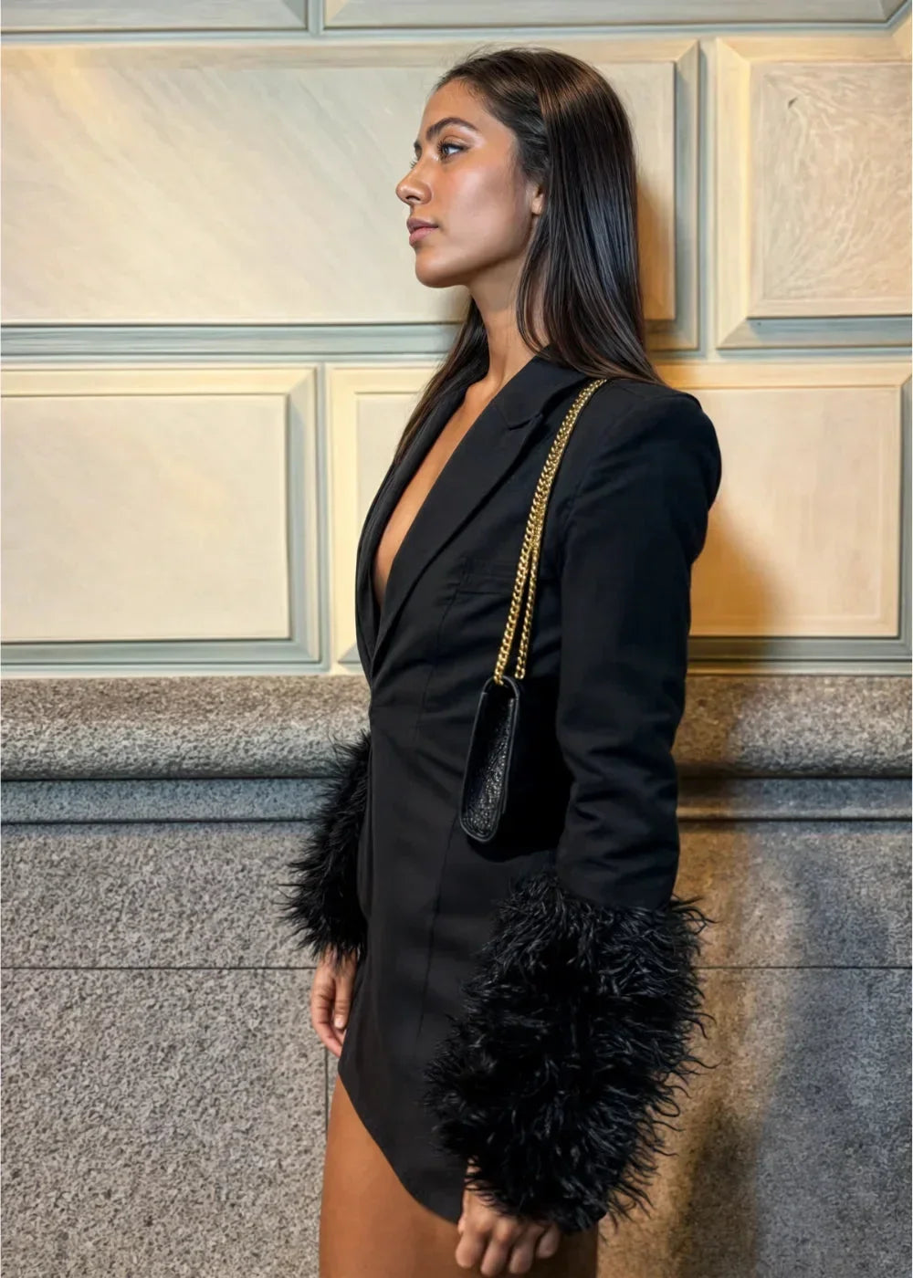 Women’s black mini dress featuring textured faux fur sleeves, crafted from soft fabric for a stylish, modern look.