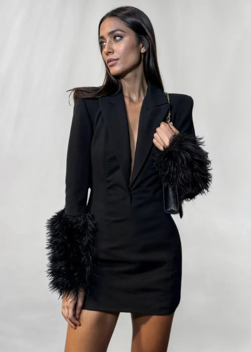 Women’s black mini dress featuring textured faux fur sleeves, crafted from soft fabric for comfort and style.