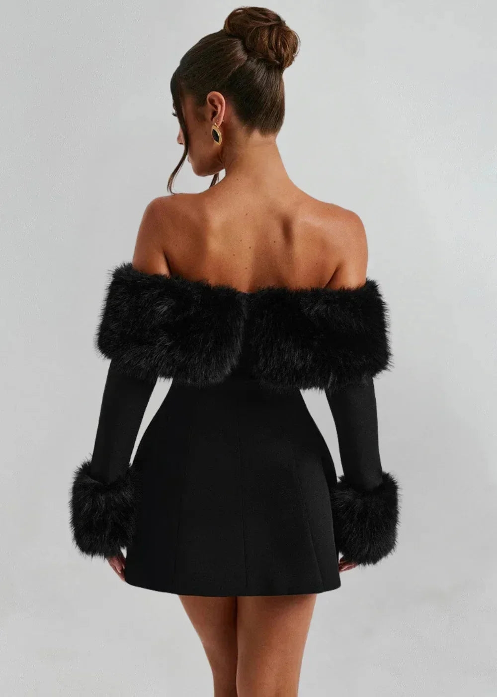 Women's black off-shoulder mini dress made of soft fabric, featuring chic fur details along the sleeves and hem.