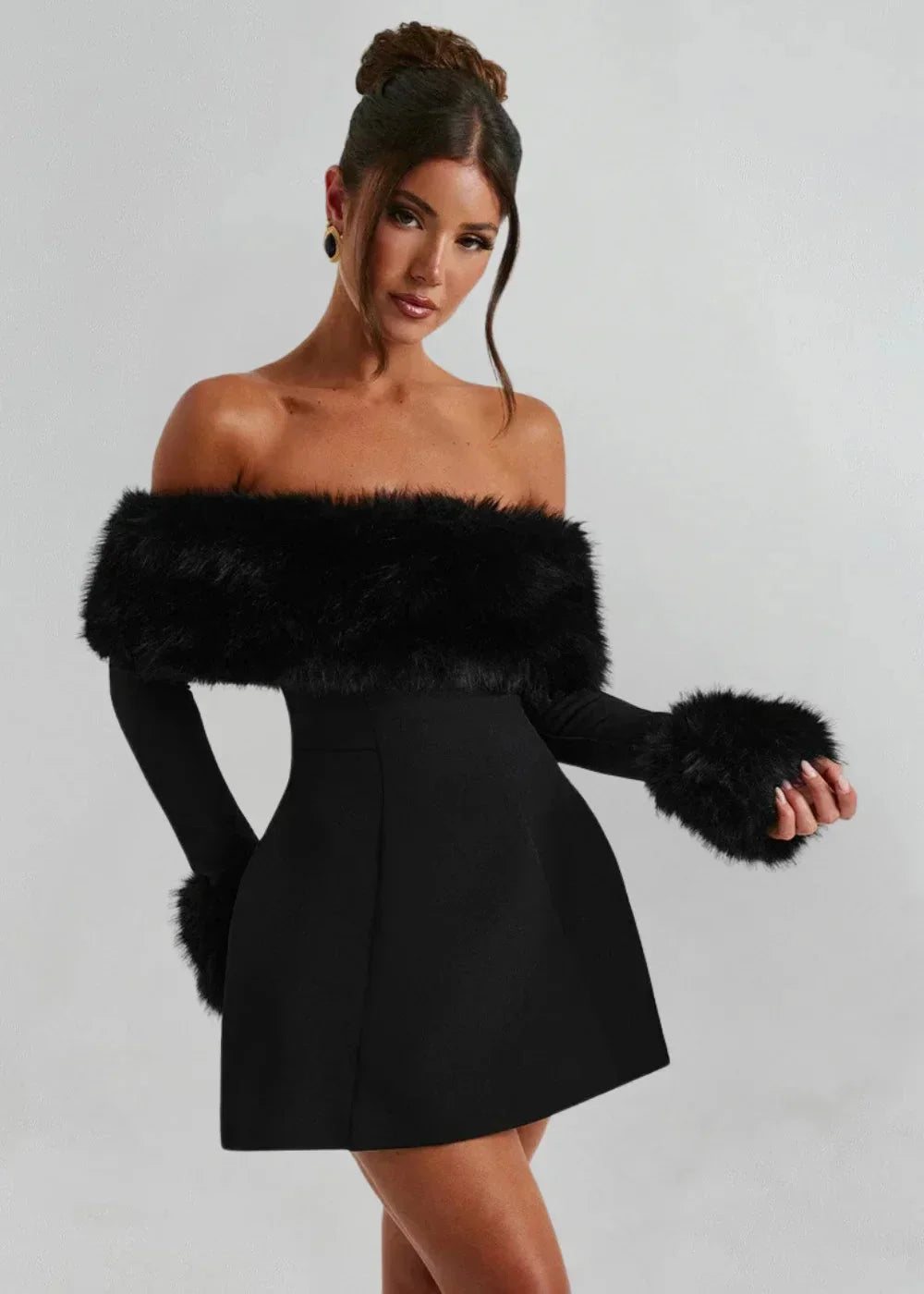 Women's black off-shoulder mini dress made from soft fabric, featuring fur details on the sleeves for added texture.