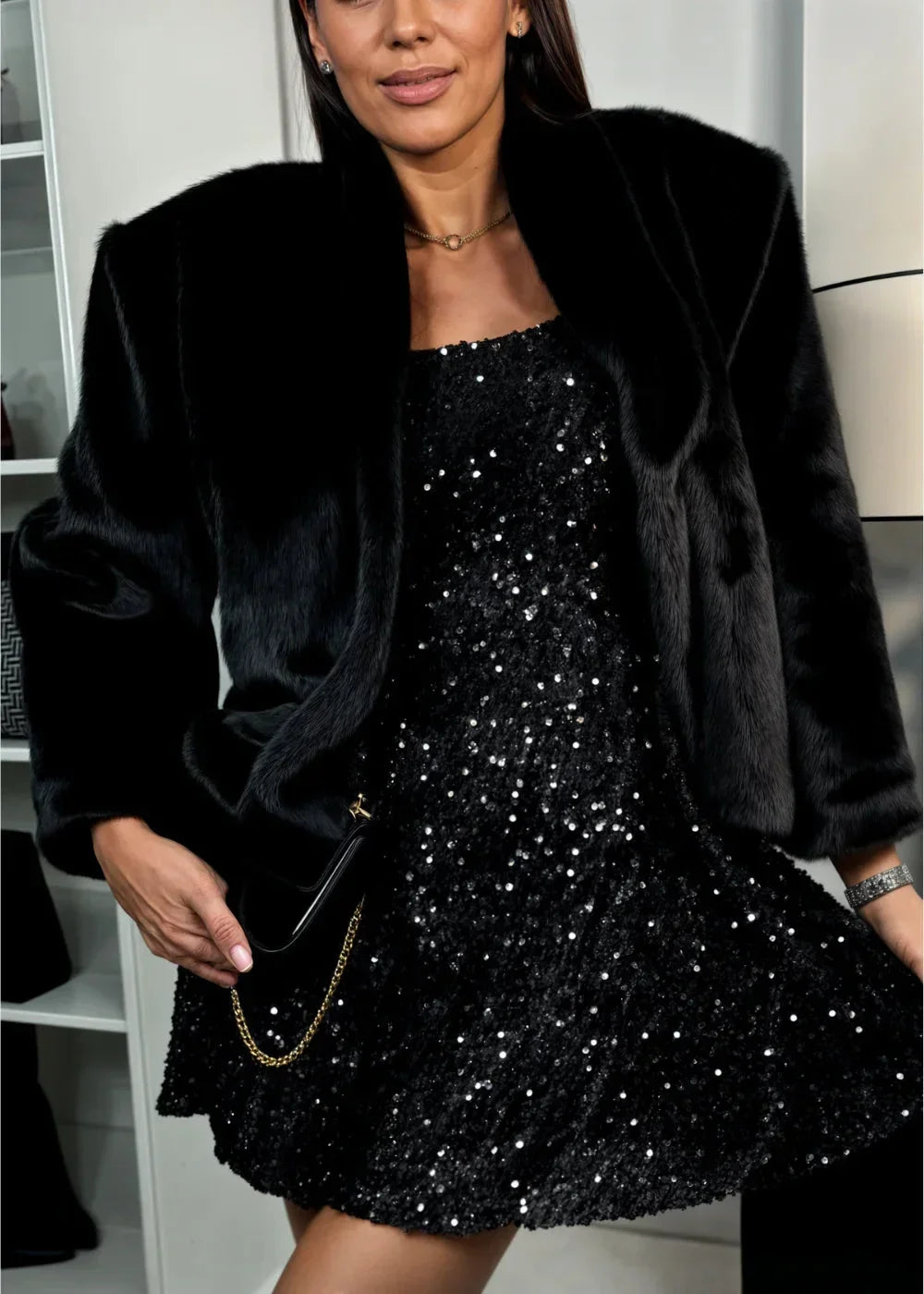 Black sequined mini dress for women featuring a sweetheart neckline and long sleeves, perfect for evening wear.