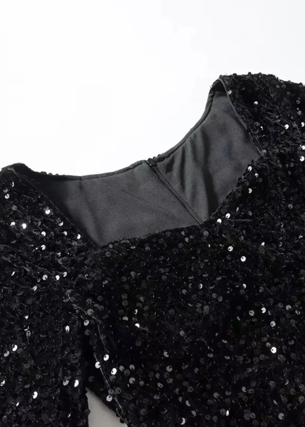 Women’s black sequined mini dress featuring a sweetheart neckline, long sleeves, and a fitted silhouette for a chic look.