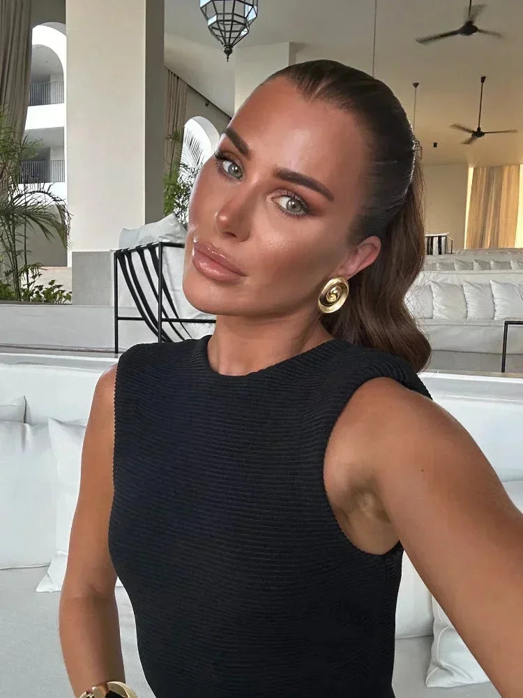 Women’s black sleeveless midi dress featuring fringe accents, made from lightweight fabric for a flowing, stylish look.