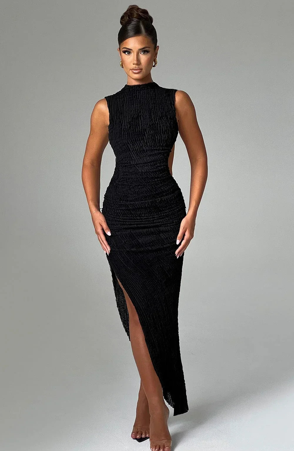 Women's black sleeveless textured maxi dress featuring side cut-out for breathability and stylish silhouette.