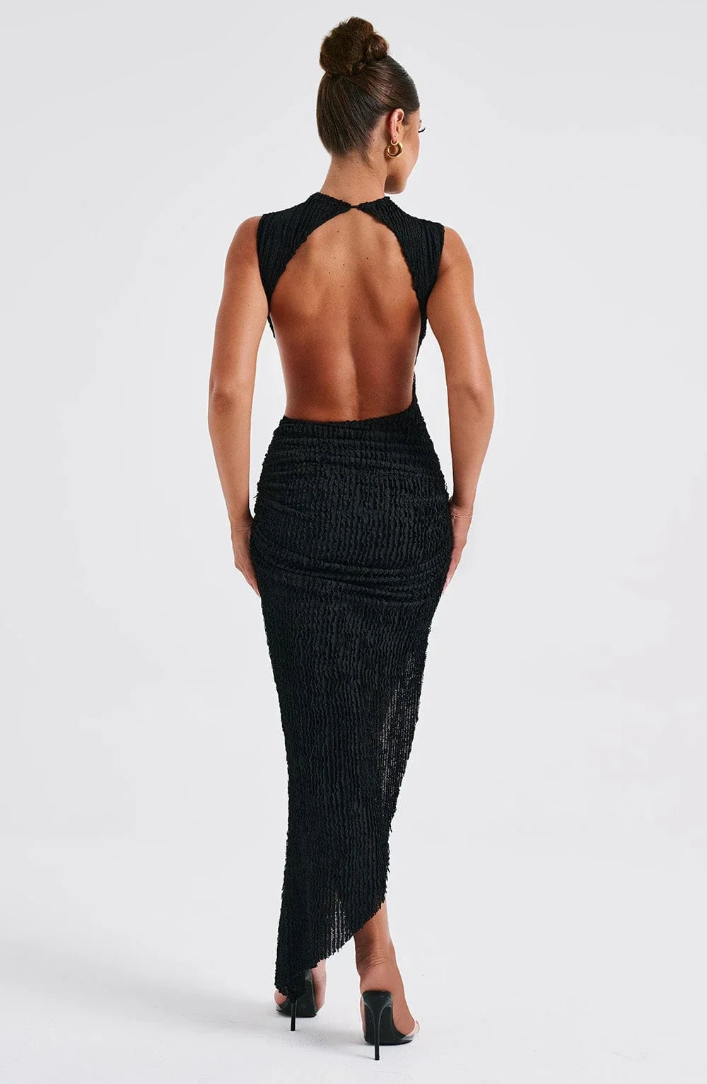 Women’s black sleeveless maxi dress in textured fabric with side cut-out detail for a chic, contemporary look.