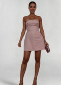 Women’s pink strapless mini dress made of soft fabric, featuring a fitted design and includes a matching pink clutch.