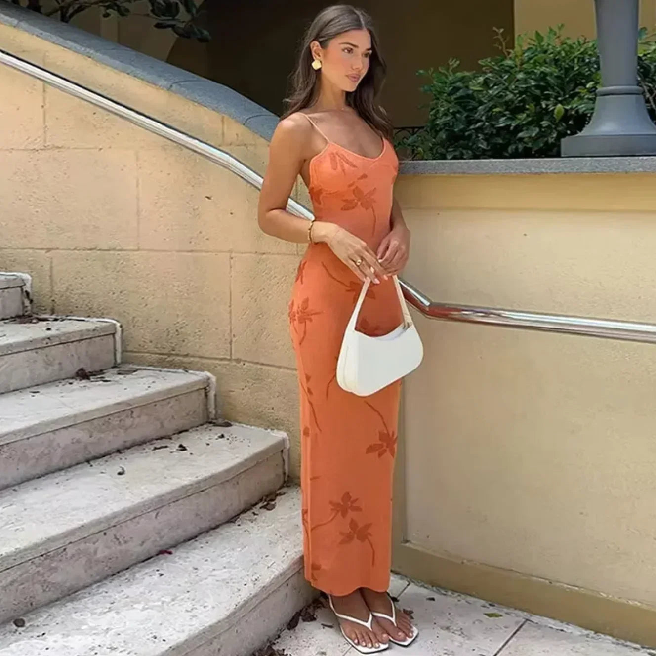 Women’s coral slip maxi dress featuring a floral pattern, made from lightweight fabric for comfort and ease of movement.