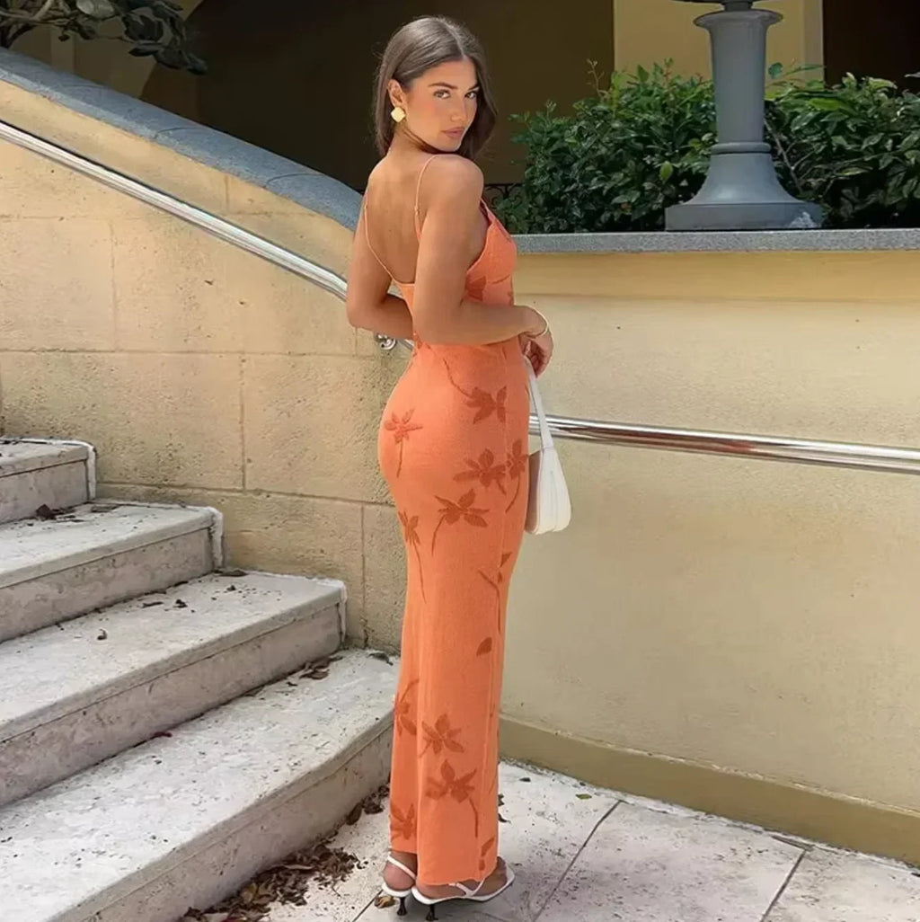 Women’s coral slip maxi dress in orange, featuring a floral pattern and lightweight fabric for comfort and ease of wear.