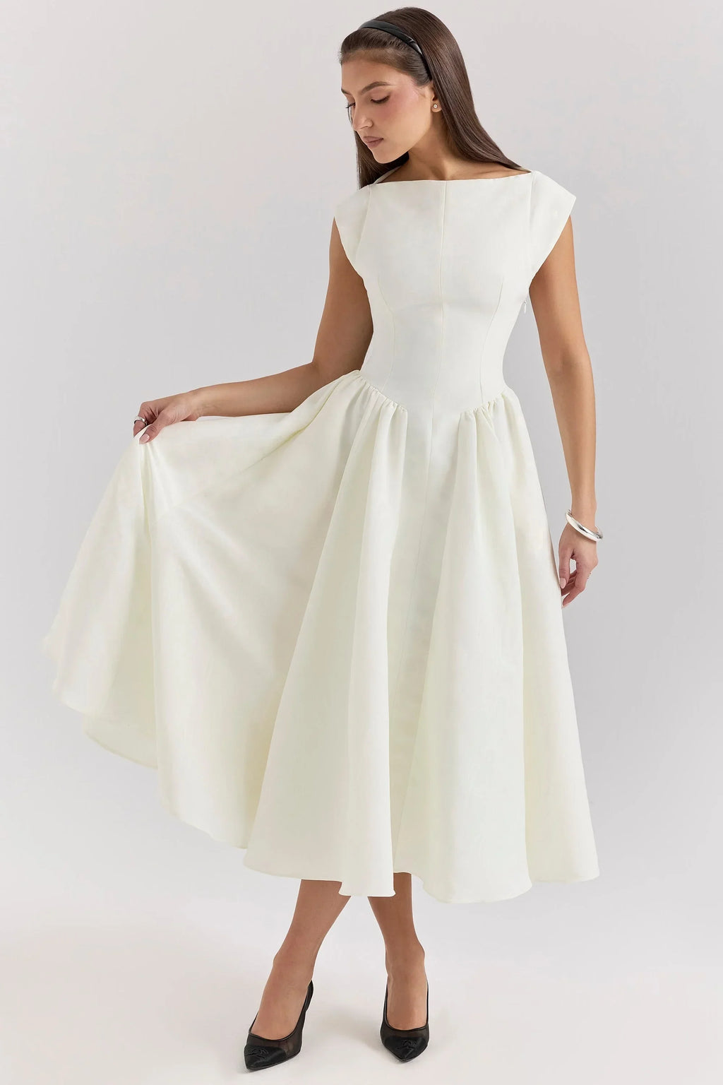 Women’s midi dress with a sculpted bodice, cap sleeves, made from soft fabric, featuring a fitted silhouette and flared…