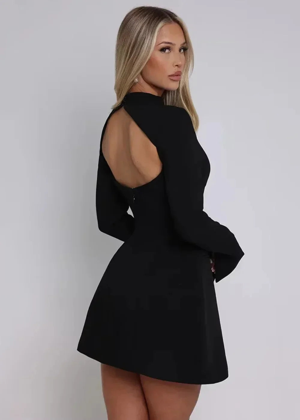 Women's flared mini dress with long sleeves and an open back, made from soft cotton blend for comfort and style.
