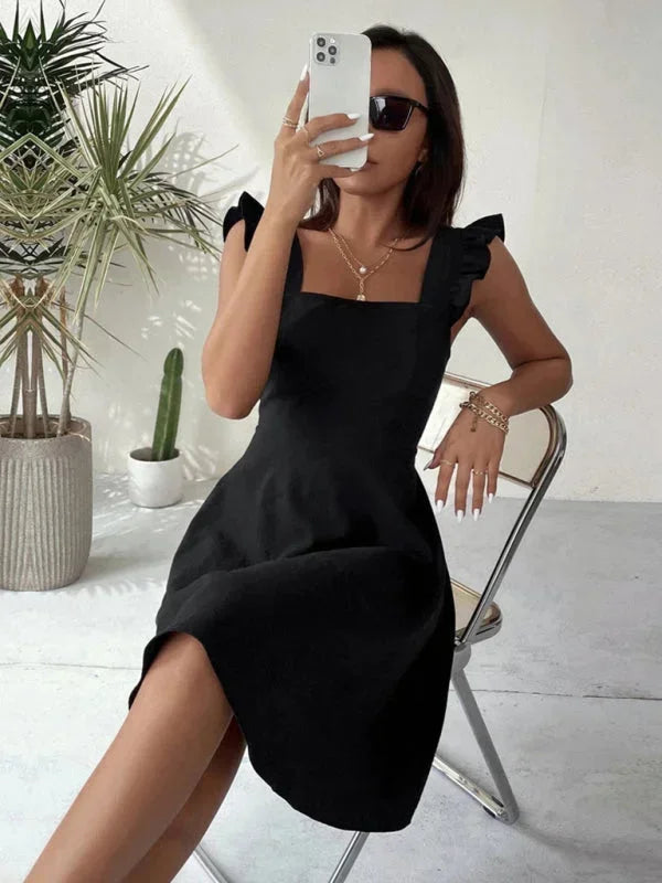 Women’s flared mini dress in soft cotton, featuring ruffle shoulder details for a playful, stylish look.