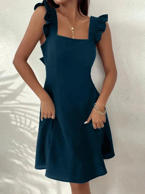 Women's flared mini dress in soft fabric featuring ruffle shoulder details and a playful cut for a breezy, stylish look.