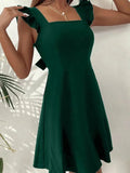 Green flared mini dress with ruffle shoulder details, crafted from lightweight fabric for a comfortable fit.
