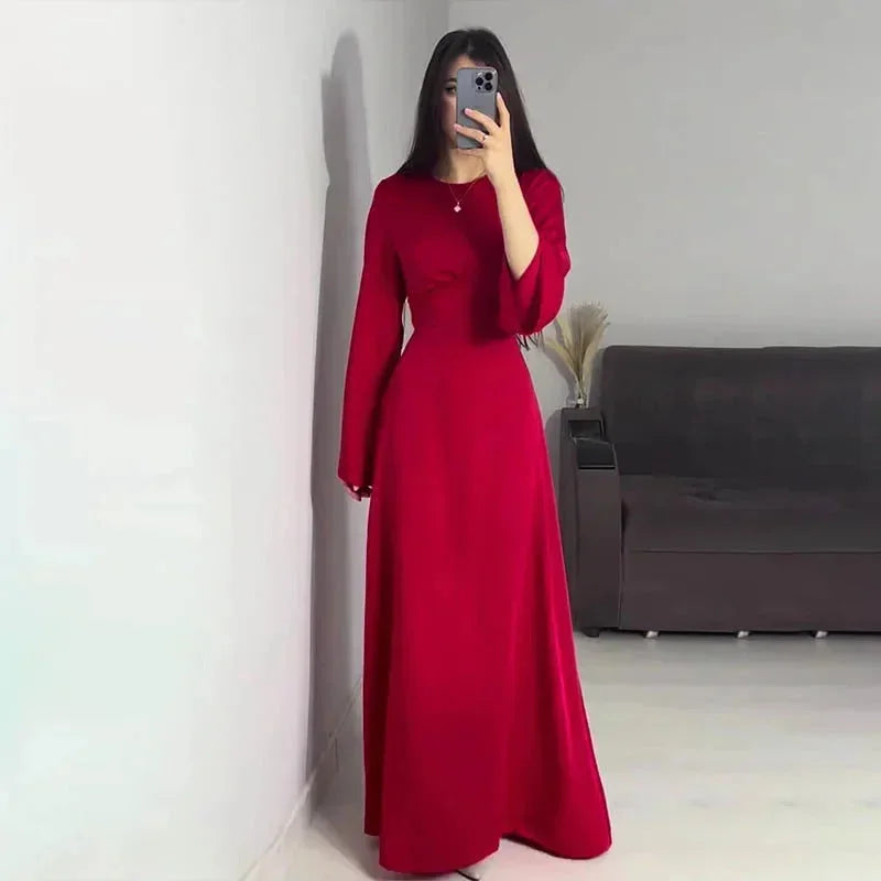Red women's floor-length A-line maxi dress with bell sleeves, crafted from lightweight fabric for comfortable wear.