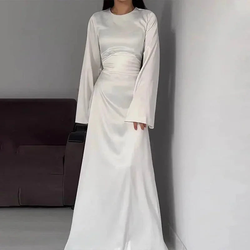 White floor-length A-line maxi dress for women, featuring bell sleeves and made from lightweight, breathable fabric.