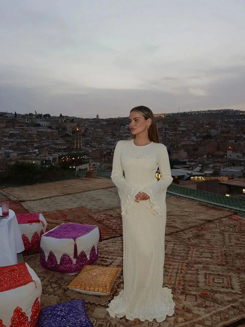 Women’s floor-length pleated maxi dress with flared sleeves, featuring lightweight fabric and elegant pleat details…