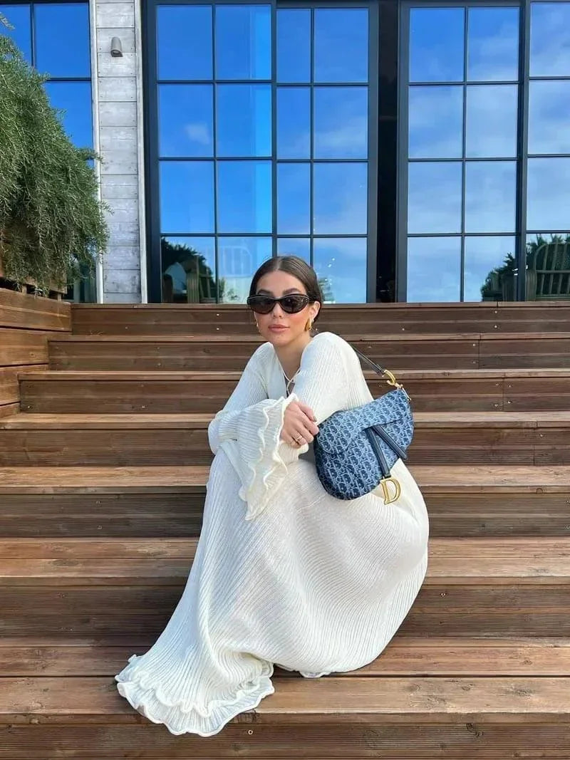 Women’s floor-length pleated maxi dress with flared sleeves, crafted from lightweight fabric for comfort and style.