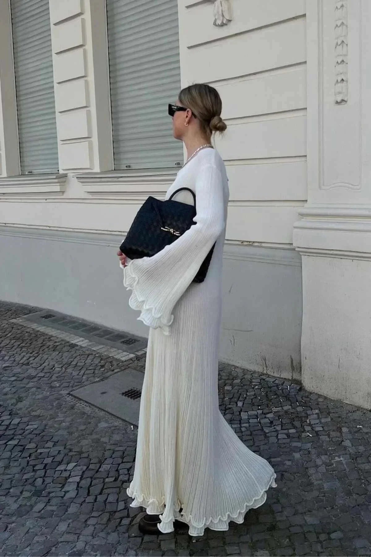 White floor-length pleated maxi dress for women, featuring flared sleeves and a lightweight, breathable fabric for comfort.