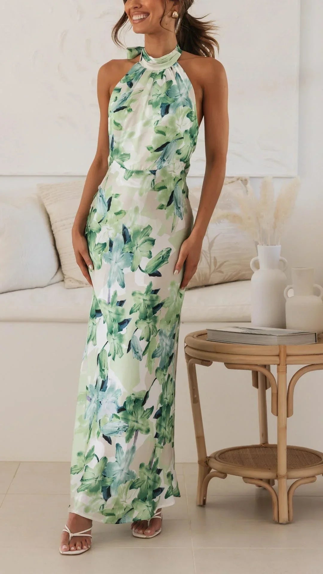 Women’s floral maxi dress with halter neckline, crafted from lightweight cotton, featuring vibrant floral patterns and a…