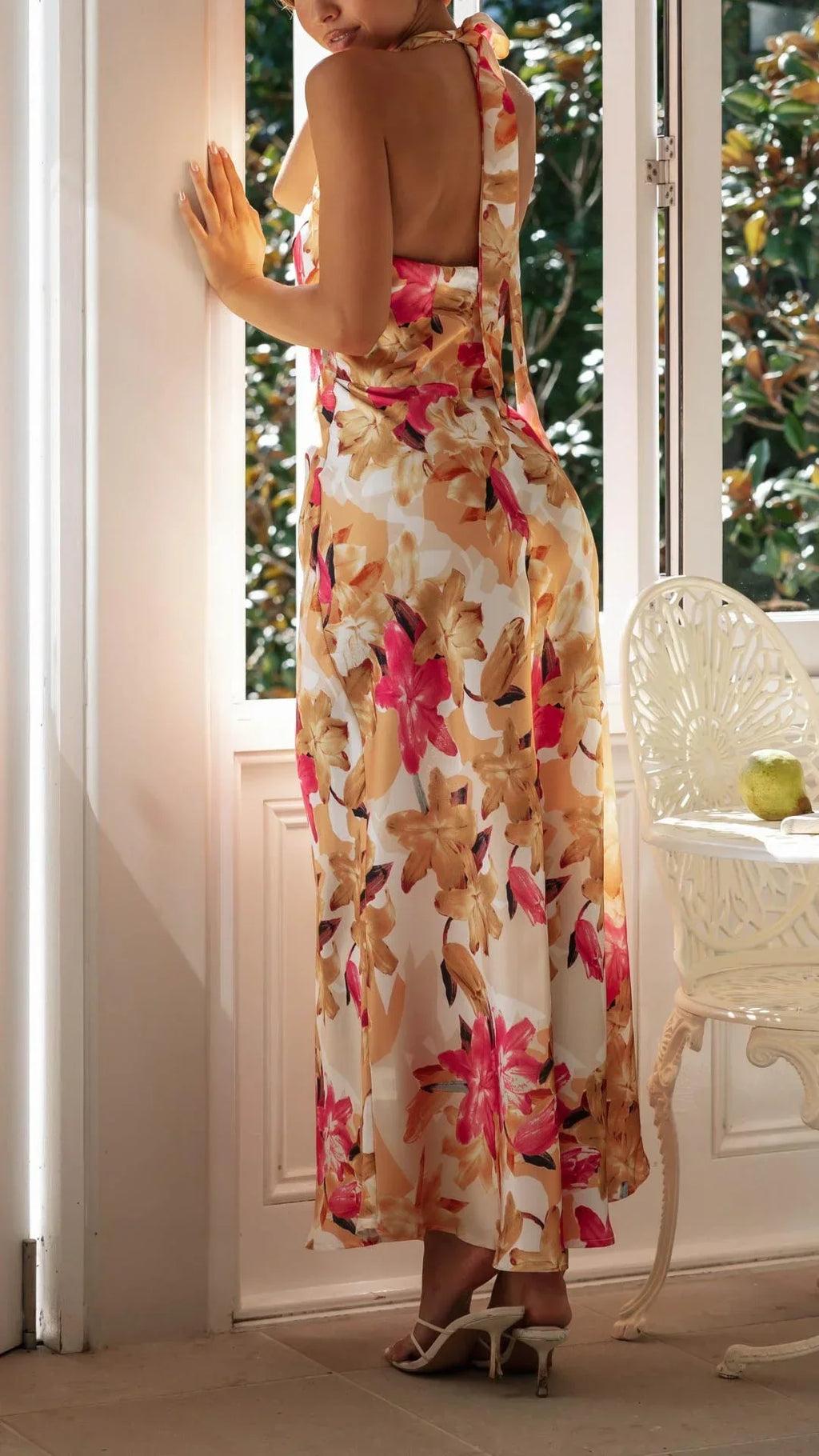 Women’s floral maxi dress featuring a halter neckline, made from soft, breathable fabric with a flowing, full-length design.