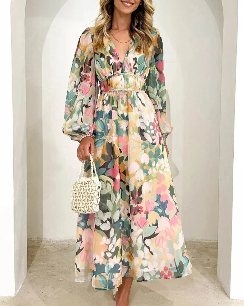 Women’s floral maxi dress featuring long puff sleeves, a v-neckline, and lightweight fabric for comfort and style.