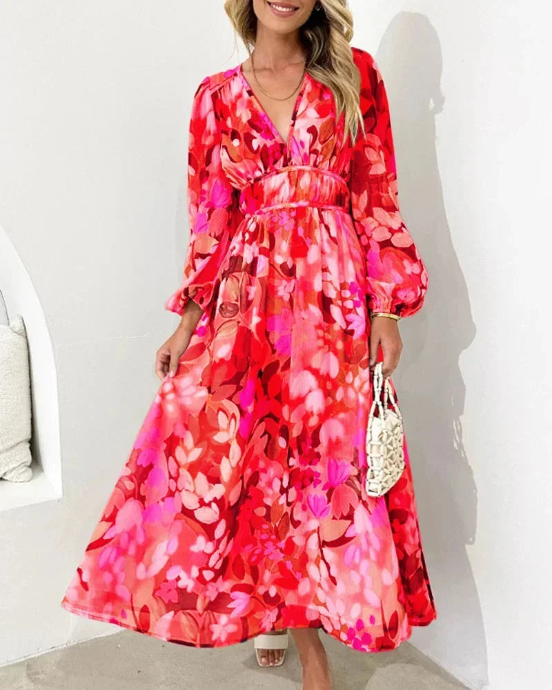 Red women's floral maxi dress featuring long puff sleeves, a v-neckline, and a flowy fit, perfect for warm weather outings.