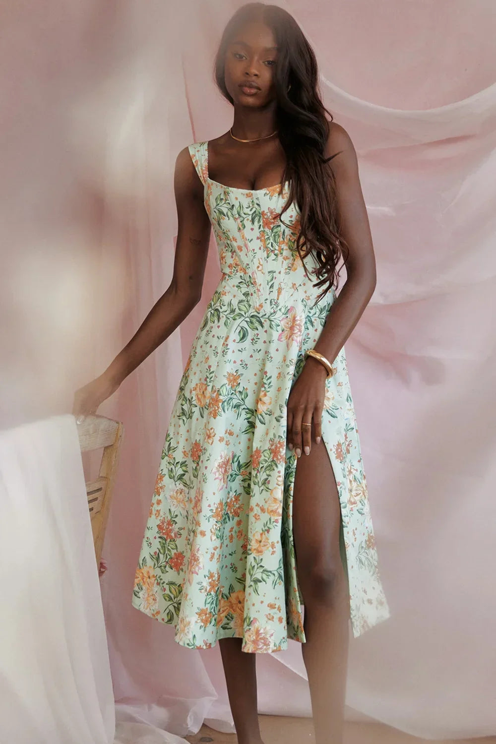 Women’s floral off-shoulder midi dress featuring a fitted bodice and lightweight fabric, perfect for warm weather occasions.