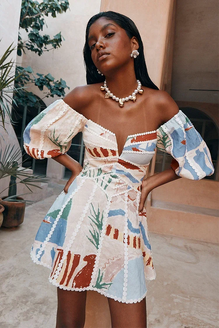 Women’s floral off-shoulder mini dress in sand, featuring puff sleeves and soft cotton fabric for a comfortable fit.