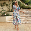 Multicolor women's midi dress with floral pattern, puff sleeves, and an elastic waist for comfort and style.