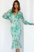 Green women’s floral sheer midi dress with puffed sleeves, featuring lightweight fabric and a feminine floral pattern.