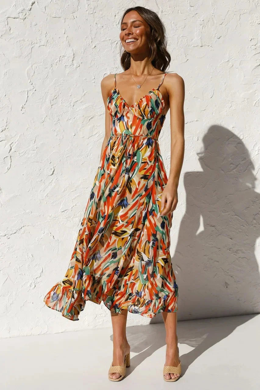 Orange women's flowy maxi dress with spaghetti straps, featuring an abstract print and lightweight fabric for comfortable…