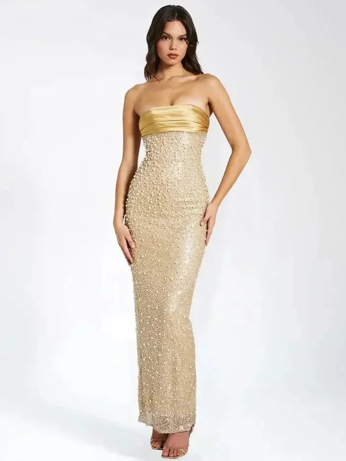 Gold strapless maxi dress for women, featuring embellished detailing and a flowing silhouette, ideal for formal occasions.