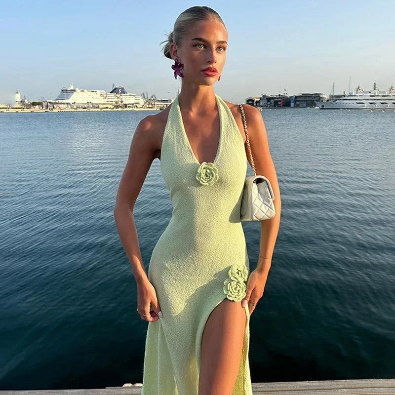 Green halter neck maxi dress featuring floral detailing, made from lightweight fabric for comfort and a flowy silhouette.