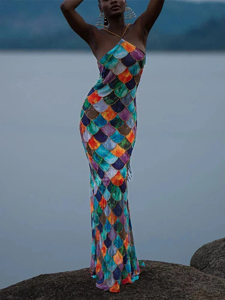 Halter neck maxi dress featuring a vibrant multicolor scale pattern, made from lightweight, breathable fabric for summer…