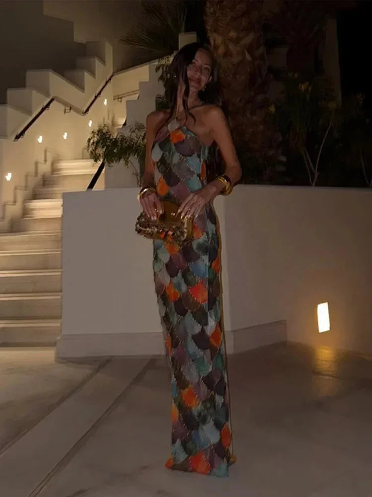 Women’s halter neck maxi dress featuring a vibrant multicolor scale pattern, made from lightweight, breathable fabric.