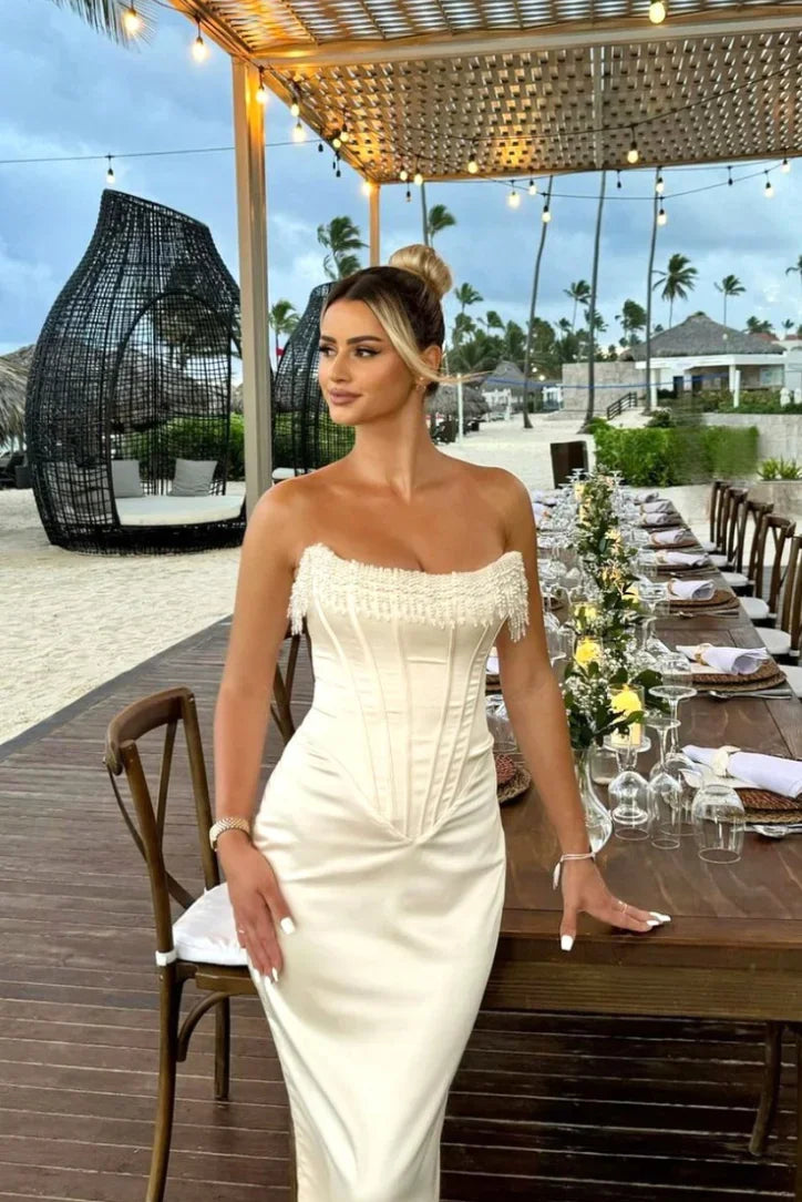 Women’s ivory strapless corset midi dress with beaded detailing, featuring a fitted silhouette and soft fabric for comfort.