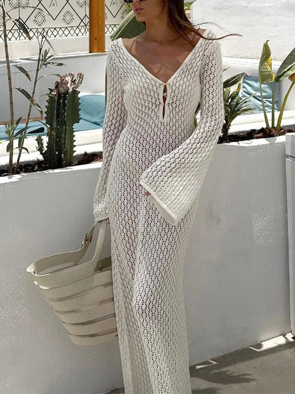 Women’s long knit dress featuring a tie front and flared sleeves, crafted from soft, stretchy fabric for comfort and style.