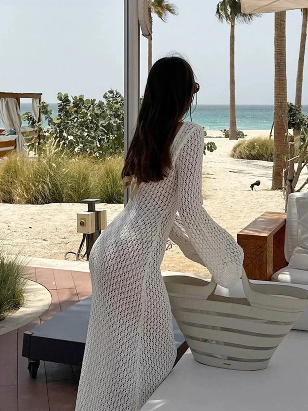 Women's long knit dress featuring a tie front, flared sleeves, and soft, breathable fabric for comfort and style.