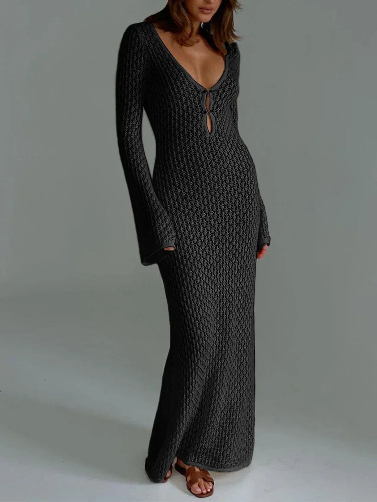 Black women’s long knit dress featuring a tie front detail and flared sleeves, crafted from soft, breathable fabric.
