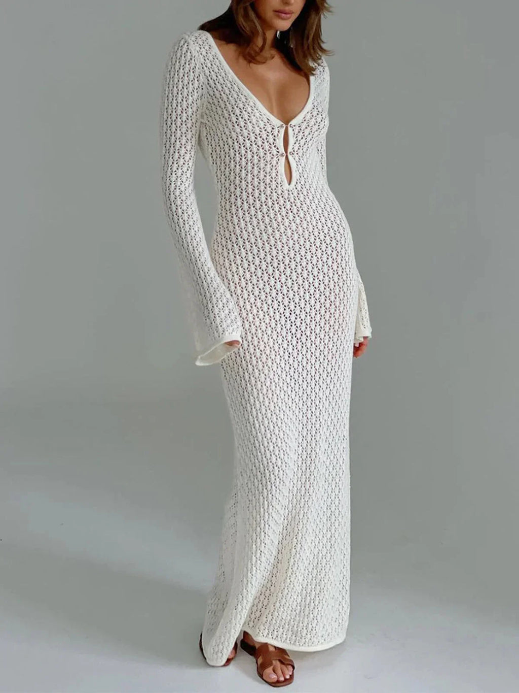 White long knit dress with tie front and flared sleeves, made from soft, breathable fabric for comfort and style.